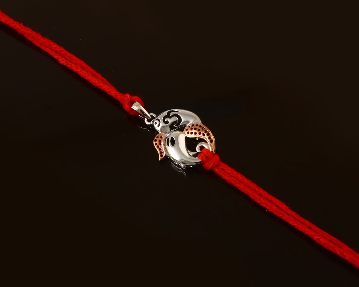 925 Silver Ganesh Ji Rakhi with Rose Gold Accents on Red Thread - Zirak Silver