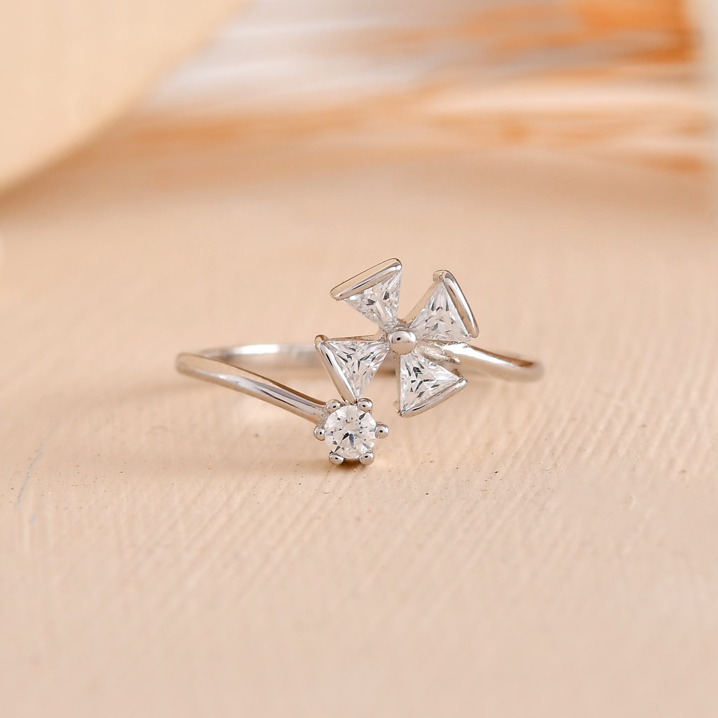 Sterling Silver Pinwheel Ring with Trillion-Cut CZ & Round Solitaire – Modern Open Flower Band