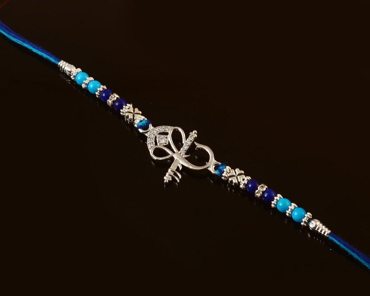 Ganesh Ji Rakhi | Elegant Silver Ganesha Rakhi with Peach-Green Beads | Rakhi for Brother - Zirak Silver