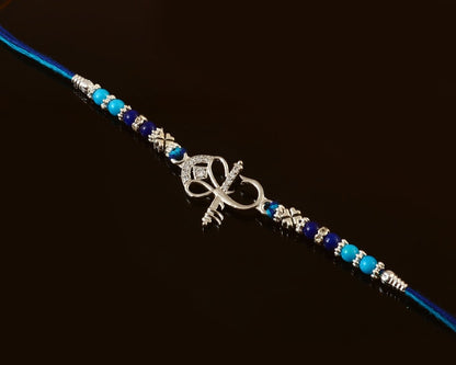 Ganesh Ji Rakhi | Elegant Silver Ganesha Rakhi with Peach-Green Beads | Rakhi for Brother - Zirak Silver